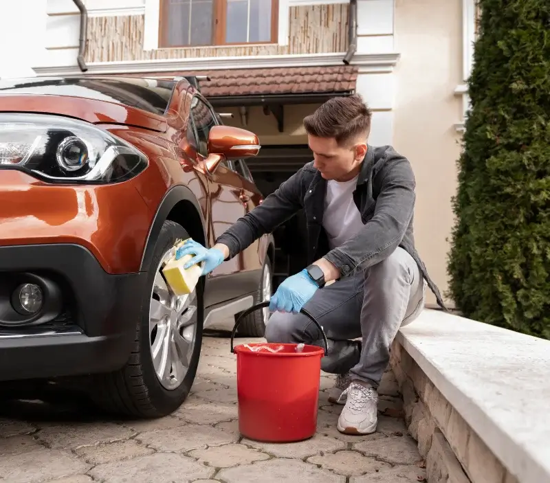 Lavage auto à domicile Saint-Priest-des-Champs : professionnel intervenant sur un véhicule